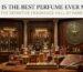 A luxurious, vintage-style library room with wood paneling and glass cabinets filled with perfume bottles. In the foreground, a display table holds a collection of elegant fragrances next to a quill and a large, leather-bound book titled "THE DEFINITIVE FRAGRANCE HALL OF FAME." Text at the top reads, "WHAT IS THE BEST PERFUME EVER MADE?"